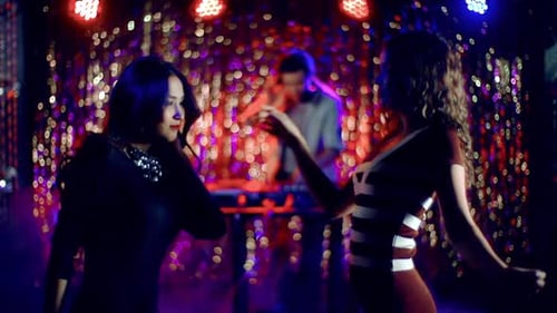 People Dancing While DJ Plays Music in Club