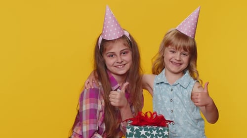Two Young Girls Celebrating Birthday with Gift