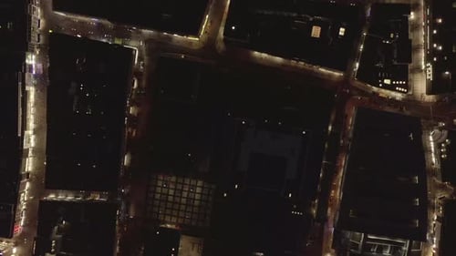 Top Down Shot of Various Buildings and Illuminated Streets in Night City