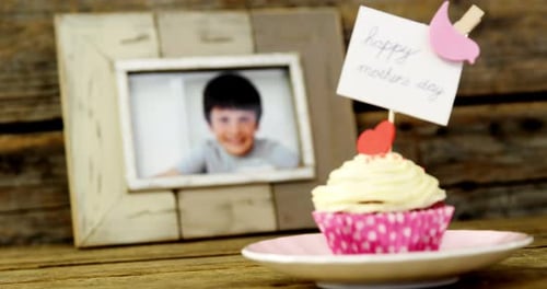 Close-up of delicious cupcake with happy mothers day label