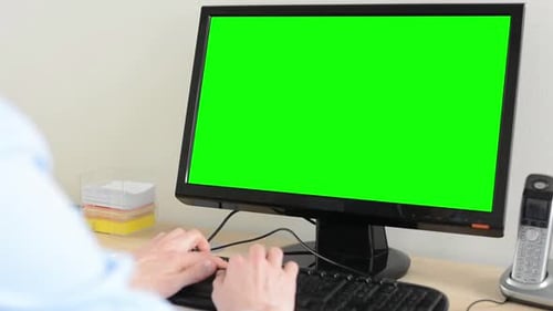 Man Works on Desktop Computer in the Office - Green Screen - Closeup