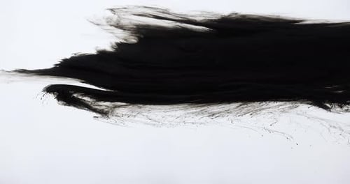 Black Ink Spreads Across White Surface