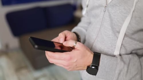 Close Up of Hand Using Smartphone Indoors