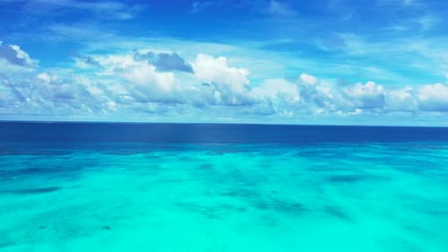 Luxury birds eye tourism shot of a paradise sunny white sand beach and aqua blue water background