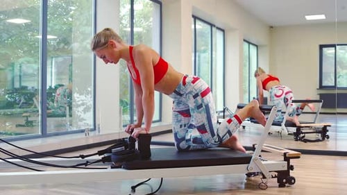 Woman Doing Pilates on Machine in Fitness Studio