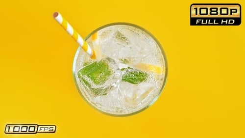 Refreshing Sparkling Drink with Ice on Yellow Background