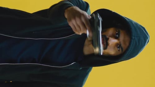 Young Man Threatening with Gun