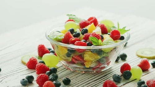 Colorful Fruit Salad in Glass Bowl on Table