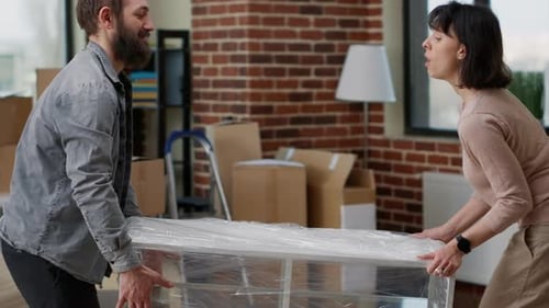 Couple Moving Shelf into New Apartment Together
