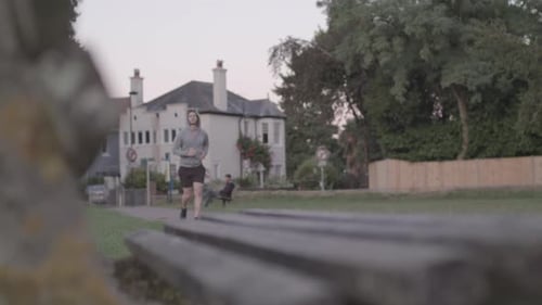Young Athletic Man Goes For a Run in The Park, In Slow Motion.