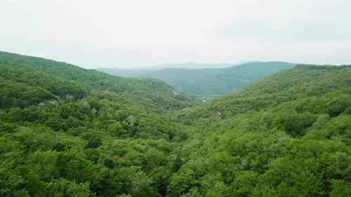 Aerial View of Caucasian Mountains and Winding Road with Cars