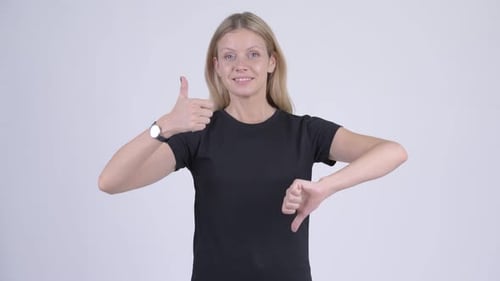 Woman Expressing Conflicting Opinions with Thumbs Up