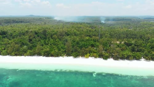 Aerial: flying over tropical beach coral reef turquoise water green forest uncon