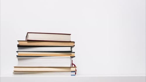 Stack of Books on White Shelf