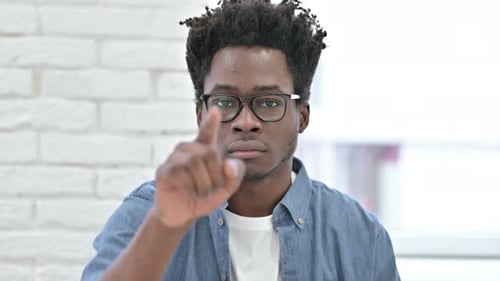 Serious Young African Man Pointing Finger