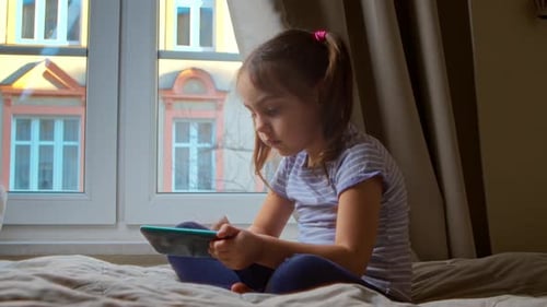Girl Using Tablet Device at Home