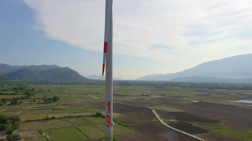 Aerial Shot of a Complex of Wind Turbines Standing on a Big Farming Field. Green Energy Concept
