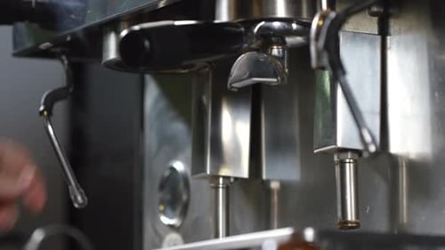 Tattooed Barista Making Two Shots of Espresso on Coffee Machine