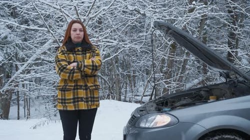 Woman Stands Near Car With Open Hood in Winter