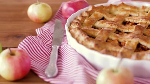 Close Up of Apple Pie and Knife on Wooden Table
