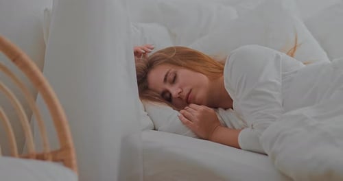 Woman Sleeping Peacefully in a Bed