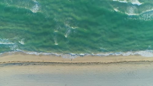 Ocean with Waves and Sandy Beach in Sunny Morning