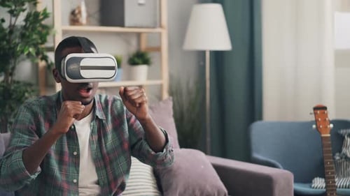 Man Wearing VR Headset Interacting with Virtual World