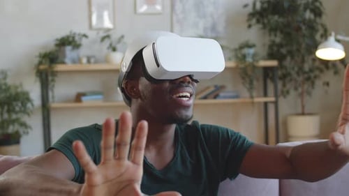 Excited Young Adult Using Virtual Reality Headset