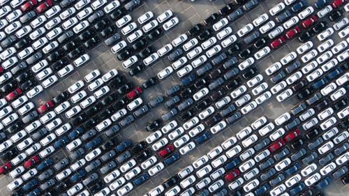 Motion Over Rows of Finished Cars at Open Warehouse Lot