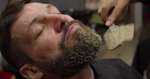 Man Getting Beard Mask Applied at Barbershop