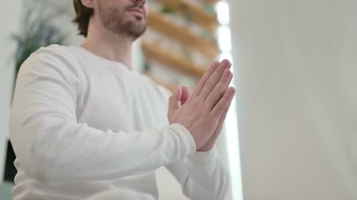 Portrait of Hands of Man Meditating on Yoga Mat at Home