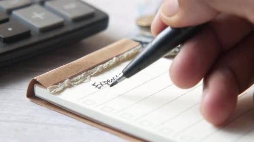 List of Utility Bills on a Paper on Table