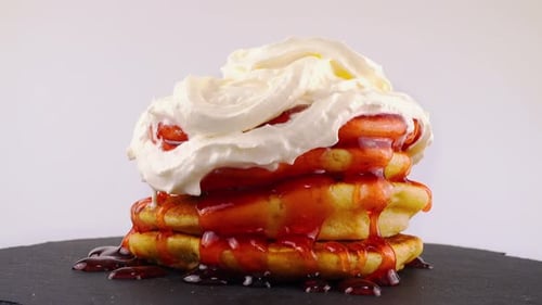 Pancakes Stacked High with Strawberry Sauce and Cream