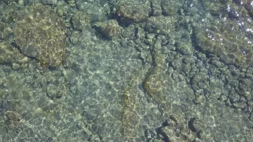 Clear transparent sea surface at summer day. Calm waves, paradise holiday vibes