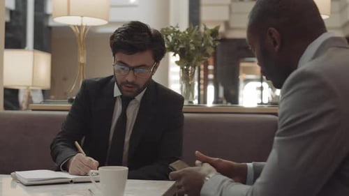 Managers Having Meeting in Cafe