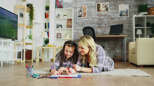 Mother and Child Drawing Together on Floor