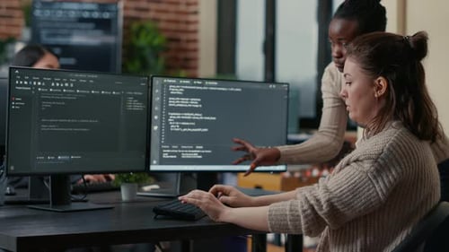 Programmers Working Together on a Dual-Screen Computer