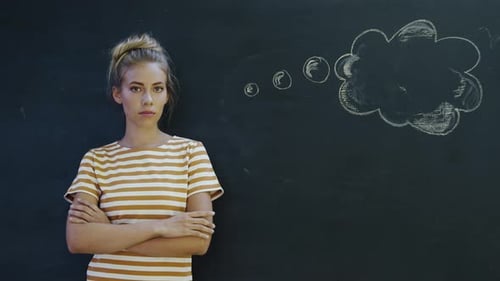Woman Standing in Front of Blackboard with Thought Bubble