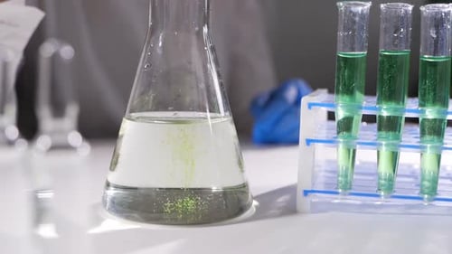 Laboratory Glassware with Green Liquid for Scientific Experiment