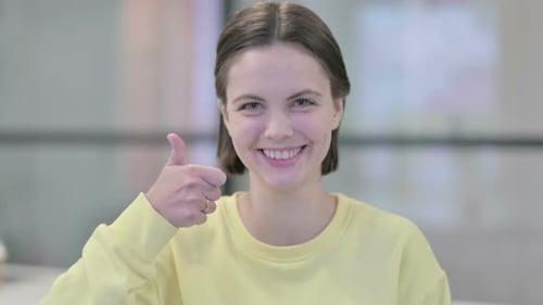 Smiling Woman Gives Thumbs Up Approval