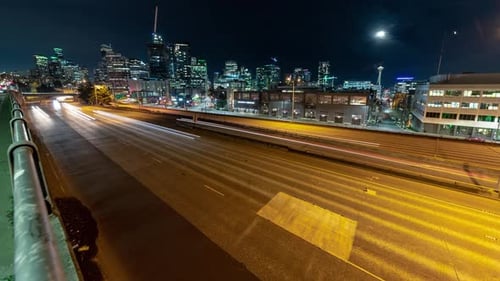 Wide City Night Timelapse With Glowing Street Lights And Freeway Car Streaks