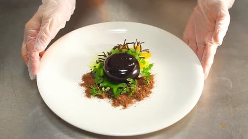 Hands of Chef Preparing Salad in Restaurant.