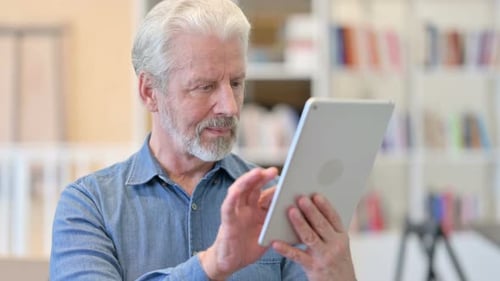 Mature Man Using Tablet at Home