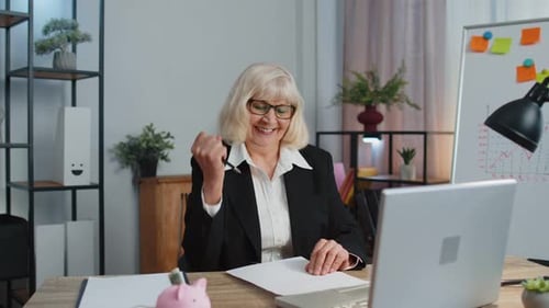 Senior Business Office Woman Analyzes Financial Charts Celebrate Success Win at Home Workplace Desk
