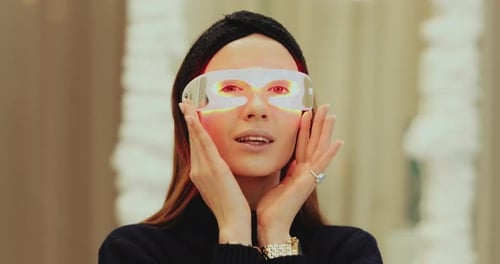 Woman Modeling Innovative Eye Light Therapy Device