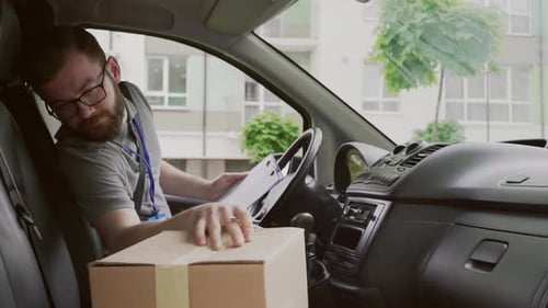 Delivery Man Checking Packages in Van