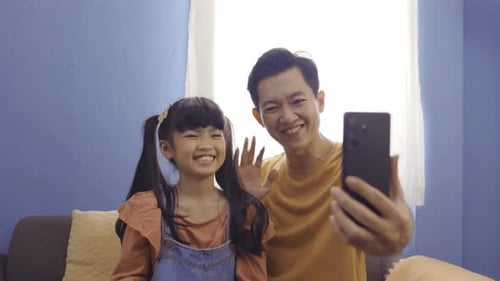 Father and Daughter Video Call Smiling and Waving