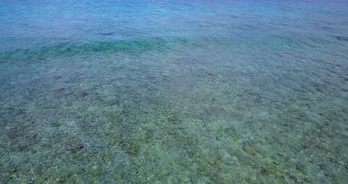 Wide angle drone abstract view of a white paradise beach and aqua blue water background in vibrant