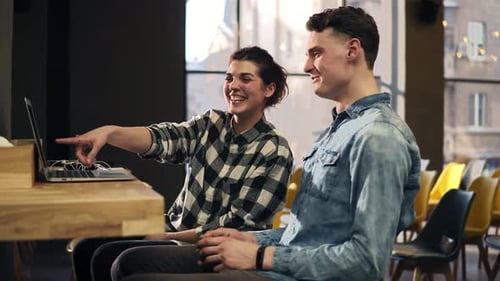 Smiling Young Adults Chatting in Urban Cafe