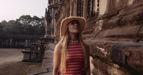 Gorgeous Female Model With the Camera Following Her Roaming in an Ancient Ruins
